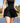 Model wearing the Flairway skort on the golf course with greenery in the background
