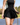 Model wearing the Flairway skort on the golf course with greenery in the background