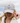 A female model wearing the Chill Out Flight hat outside with blue sky & clouds in the background
