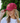 A female model wearing the Clucky Flight Hat outside with greenery in the background