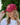 A female model wearing the Clucky Flight Hat outside with greenery in the background