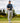 Male model wearing the Fish Finder Polo on the golf course with greenery and blue sky in the background
