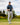 Male model wearing the Fish Finder Polo on the golf course with greenery and blue sky in the background