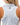 Waggle "W" on the back of the Floater Racerback Polo on a model in front of a white background