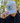 A male model wearing the Great Blue Hat outdoors with greenery in the background