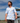 Male Model wearing the Horizon Camp shirt walking down a dock on a lake, with blue skys in the background