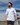 Male Model wearing the Horizon Camp shirt walking down a dock on a lake, with blue skys in the background