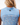 Close up on the Waggle "w' patch on the back of the Lily Pond Sleeveless Polo on a Model in front of grey background