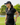 Model wearing the Loon Lake 2.0 Pique Polo on the golf course with greenery in the background