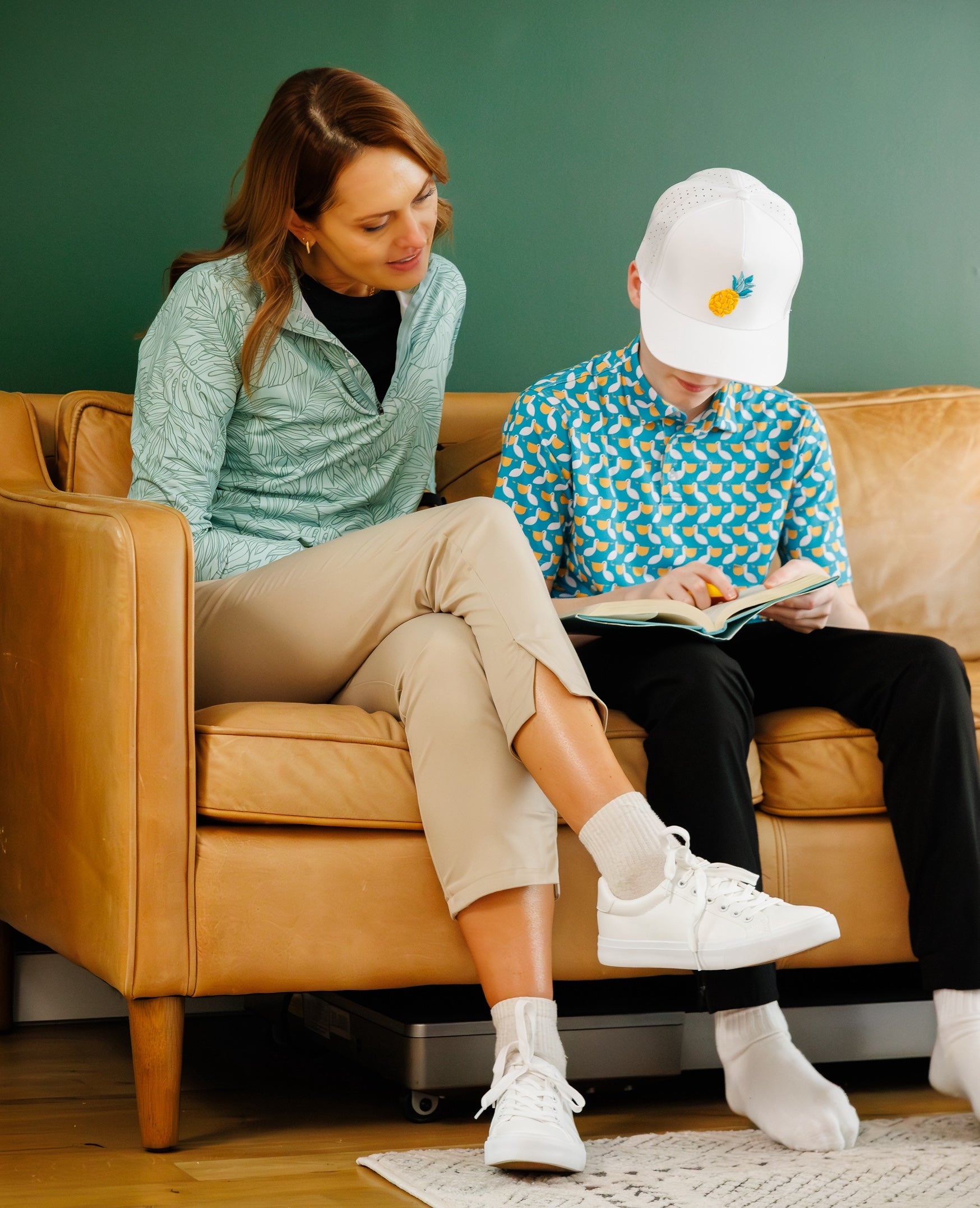 Mom and son reading on couch wearing Waggle.