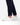 Close up on the ankle slit on the Rhythm Pants on a model in front of a white background
