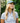 Female model wearing the Off Course Polo on the golf course with greenery in the background