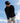 Model wearing the the Onyx Sunday Quarter Zip outside with blue sky in the background