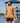 Male Model wearing the Raked Camp Shirt walking down a dock on a lake with blue skys in the background