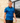 Model wearing the Wake Life Pique Polo walking down a sidewalk with a brick building as the background