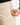 Close up on the Zippered pocket on the left leg of the Rhythm Pants on a model in front of a white background