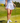 Model wearing the Flairway skort on the golf course with greenery in the background