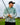 Guy holding golf club wearing a hat and camo zip hoodie