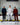 Brock Faber, Jake Oettinger, and Taylor Fox posing with matching sweatshirts, sweatpants, and hats that they each designed.