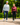 Male and female model wearing Waggle pants while walking down a path.