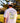Model wearing the Agave Greens GC T-Shirt outside with greenery in the background.