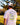 Model wearing the Agave Greens GC T-Shirt outside with greenery in the background.