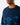 Close up on the Collar on the Alpha Wildknit Sweater on a Male Model in front of a light gray background.