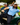 Two men posing in golf cart on a golf course.
