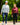 Male model wearing Zenith Hoodie and Ace Pant with a female model wearing Plume Funnel Neck and Rhythm Pants, while walking on a path.