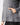 Close up on the front pocket on the Ash Linksluxe Hoodie on a model in front of a light gray background.