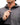 Person wearing a gray jacket with a brand logo on a white background