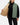 Model pulling open the Balsam Crosscut Vest to show the interior is a bunker color. The model is in front of a light gray background.