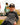 Boy wearing the Big Foot's Big Wheels T-Shirt outside leaning on a rock.