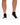 Black Pair of Wavelength Socks on a model in front of a white background
