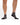 Gray Pair of Wavelength Socks on a model in front of a white background