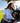 Model wearing the Boat Day Hybrid Polo riding in a golf cart on the golf course.