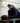Brock Faber wearing his Breakaway Bird hat leaning against the boards at a hockey rink.