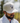 A male model wearing the Buck Up Hat outside with greenery in the background