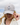 A female model wearing the Chill Out Flight hat outside with blue sky & clouds in the background