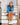 Model wearing the Cobalt Refresh Q-Zip sitting on stairs before getting ready to leave the house.