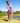 Model wearing the Concord Crossover Tank on the golf course with greenery and ultra blue sky's in the background
