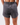 Back of the Dark Gray Women's League Shorts, on a model in front of a white background