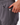 Close up on the tee pocket on the side of the dark gray women's league short. The shorts are on a model in front of a white background.