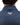 Close up on the Waggle patch on the back of the Deep Waters Twilight Quarter Zip on a model in front of a white background