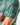 Close up the the Waggle Patch on the left sleeve of the Deer Stand Polo on a model in front of a light gray background.