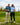 Two men posing on a golf course with golf clubs