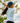 Female model wearing the Downhill Polo on the golf course with greenery in the background