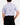 Back of the Boy's Dry Heat Polo tucked in on a model in front of a light gray background.