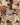 Close up on the front zipper pocket with a phone being pulled out, on the Duck Blind Sherpa Pullover on a model in front of a light gray background