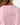 Close up on the Waggle W logo on the back of the Dusty Rose Short Sleeve Hexcore T-Shirt on a model in front of a light gray background.
